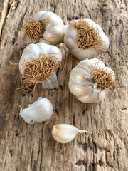garlic bunch and cloves on wooden table background 