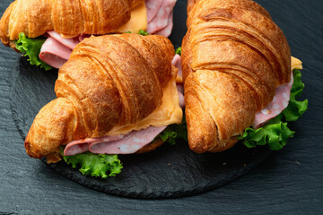 Croissant sandwich with salad ham and cheese . Top view