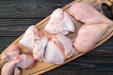 Raw mixed chicken meat parts  for cooking on rustic background © whitestorm