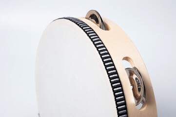 Tambourine is a percussion musical instrument, shot on a white background.
