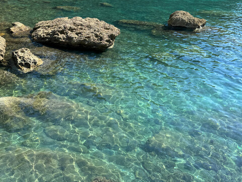 Sea beautiful clear turquoise emerald water with stones.