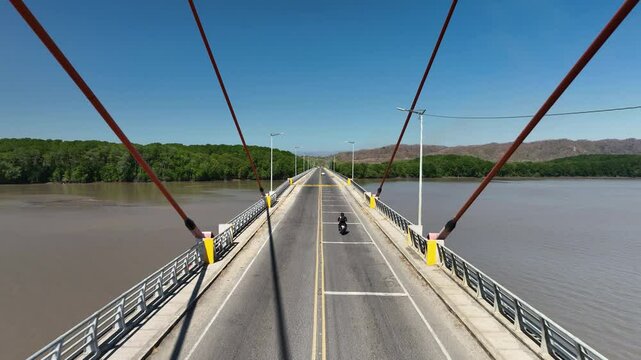 Aerial view of a motorbike driving over the Amistad Bridge in sunny Costa Rica