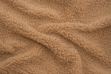 Soft beige fleece fabric with textured surface, ideal for cozy blankets and clothing