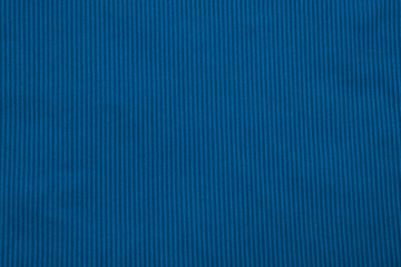 Smooth texture of deep blue fabric with vertical stripes displayed on a flat surface