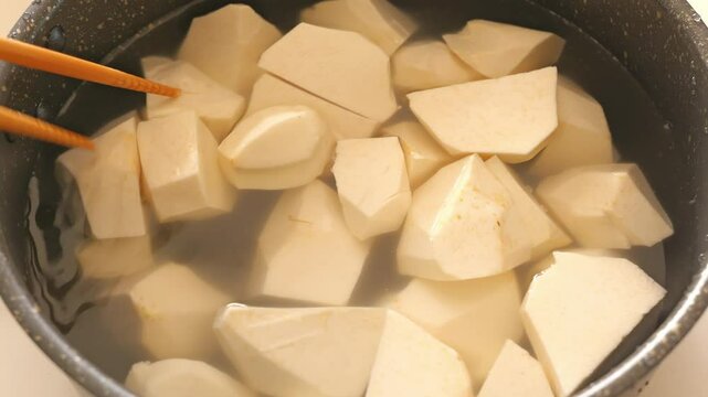 Taro being cooked, peeled and lye removed