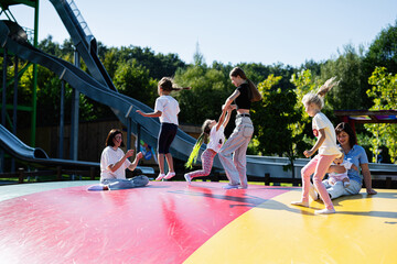 Children and women enjoying a fun day at the playground