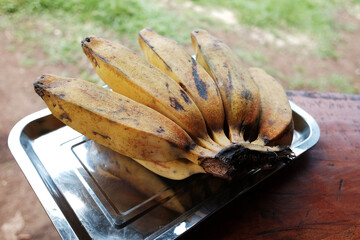Fresh Banana in aluminum tray on wooden table