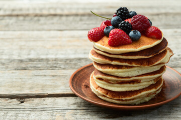 Stack of homemade american pancakes with berries . Top view