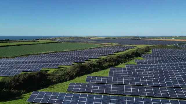 Gwithian, near Hayle, Cornwall, England: DRONE VIEWS: A solar panel farm close to the north Cornish coastline. Solar panel farms are a part of a renewables strategy for achieving net zero by 2030 (3).