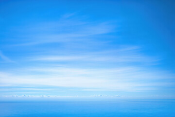 Obraz premium Clouds blue sky with the ocean on the horizon
