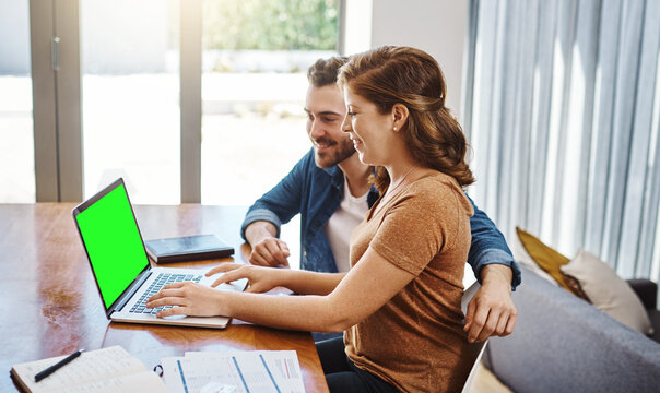 Chroma key, couple and happy with laptop in home for mortgage investment, budget savings or paperwork. People, green screen and smile at dining table for good credit score or loan application success - Powered by Adobe