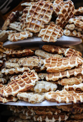 a stack of waffles sprinkled with powdered sugar