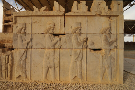 Stone bas-relief of Assyrian warriors with spears at ruins of Persepolis. It is UNESCO world heritage site located in Shiraz, Iran.
