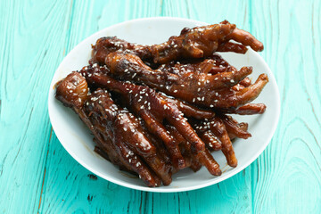 Caramelized korean or Chinese chicken foots ( paws ) with sesame . Top view