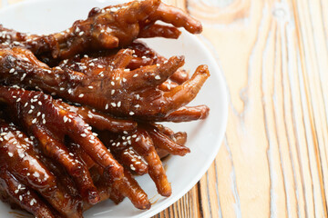 Caramelized korean or Chinese chicken foots ( paws ) with sesame . Top view