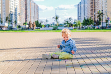 Little cute smiling girl on the children's outdoor playground