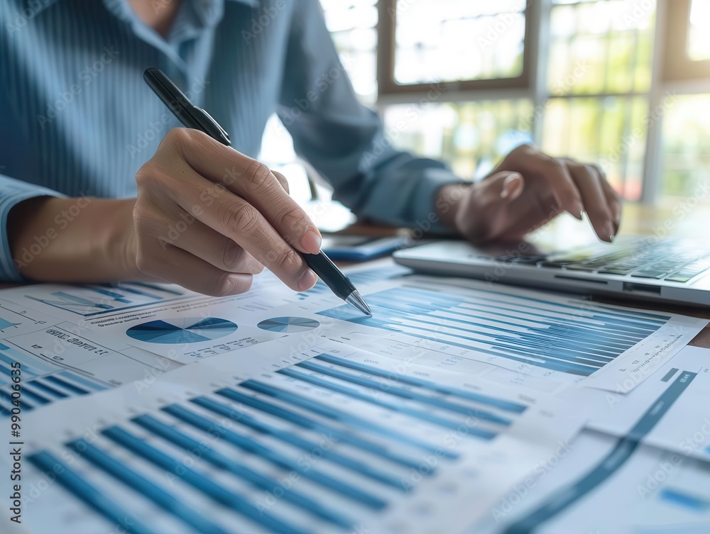 Poster business professional analyzing financial data and charts on paper with laptop in background during 