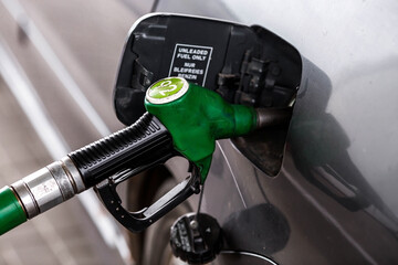 The gas station. Filling the car with gasoline. A Russian fuel dispenser in the fuel tank of a car...