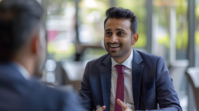 South Asians Business Partners Striking a Successful Deal at a Corporate Modern Meeting Room. Two Young Indian Businessmen Discussing Investment Opportunities, Strategy, Financing