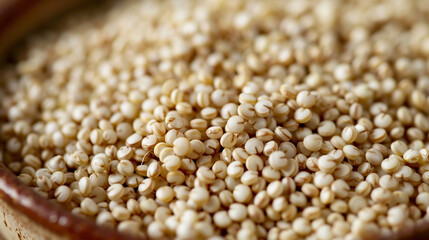 Fototapeta premium A medium close-up of raw quinoa grains in a small ceramic bowl, with their tiny round shapes creating a textured and detailed image.