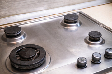 Polished gas cooker after washing. Perfectly clean gas cooker after being washed with polishing chemicals. The result of washing the burners.