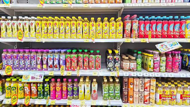 Row of Various flavoured of green tea bottles on market shelves. Window display of green tea in supermarket. Thailand, September 24, 2024