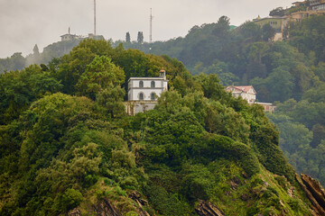 Saint Klara the lighthouse on the top of Santa Clara island in San Sebastian, Spain