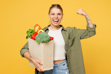 Young woman wear casual clothes hold bag for takeaway mock up with food products show hand biceps...