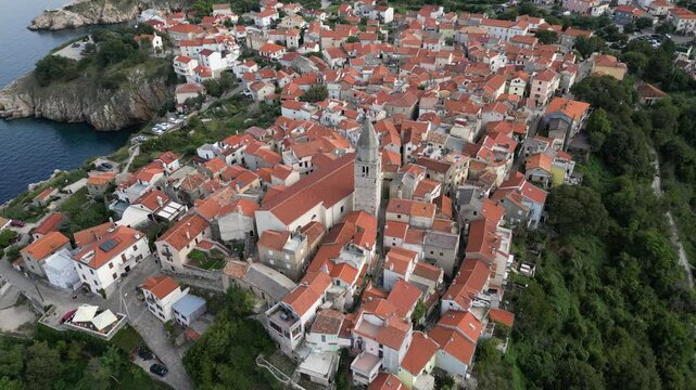 Video footage of Croatia, island Krk, Vrbnik. Aerial view of the roofs of houses, the Gothic Chapel of the Rosary, the Chapel of St. John in the Parish Church of the Assumption 