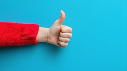 Hand in red sweater giving a thumbs up gesture against a blue background.