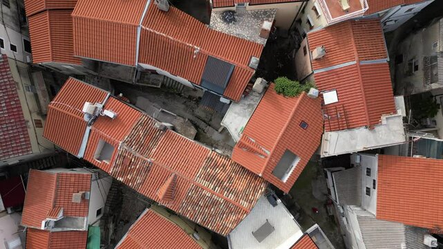 Video footage of Croatia, island Krk, Vrbnik. Aerial view from above of the roofs of houses, the Gothic Chapel of the Rosary, the Chapel of St. John in the Parish Church of the Assumption 