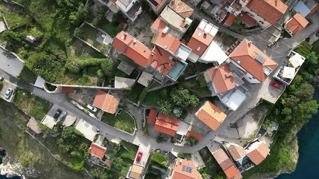 Video footage of Croatia, island Krk, Vrbnik. Aerial view from above of the roofs of houses, the Gothic Chapel of the Rosary, the Chapel of St. John in the Parish Church of the Assumption 