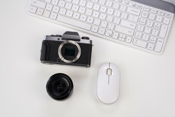 camera with computer mouse, lenses and keyboard on white background