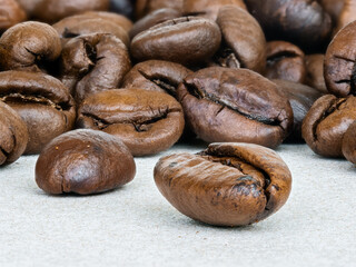 Macro photo of coffee beans on ceramic surface