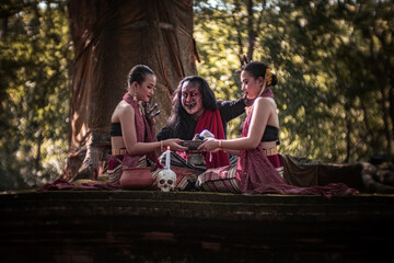 The image of an angry demon with dark hair and a beard, expressing a seriousness that mixes horror and humor, with a young woman in a traditional Thai costume, is perfect for Halloween.