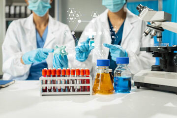 Chemist scientist holding test tube and tablet conducting experiment in laboratory with equipment,...