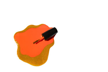 A bottle of orange nail polish with a brush, spilled on a white surface, surrounded by a gold...