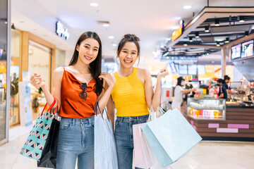 Portrait of Asian attractive two girl shopping indoors in shopping mall. 