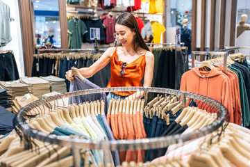 Asian beautiful young women look product of clothes in shopping mall. 