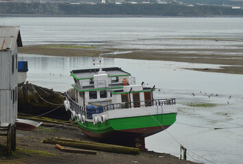 a fishing boat stranded in a town in Chiloe in Chile
