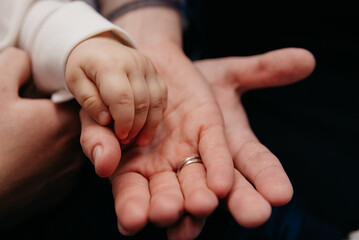 Three hands, father, mother and child