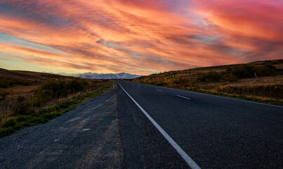 The Road trip view of  travel with mountain view of autumn scene and  foggy in the morning with sunrise sky scene at fiordland national park