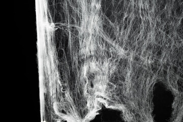 Spooky creepy cobweb spiders web covered a black background. Abstract halloween background.