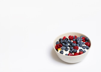 a bowl of fruits in white background. with a place for lettering. organic food for people. healthy lifestyle