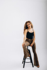 beautiful woman in tiger pants on a white background