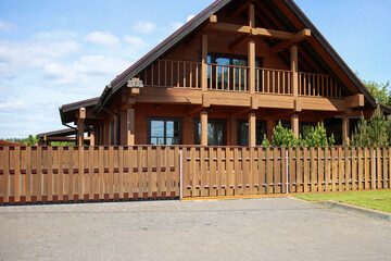 Modern eco-friendly wooden house with fence