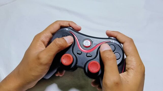 man playing a black game console joystick enthusiastically, on a white background. gamers play console games with game sticks