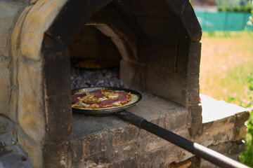 a workshop for children on cooking pizza in an old wood-fired oven