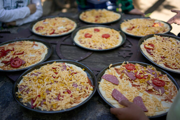 a workshop for children on cooking pizza in an old wood-fired oven