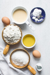 Overhead view of mise en place of ingredients for making a vanilla cake, flatlay of ingredients for making vanilla pound cake, process of making cake